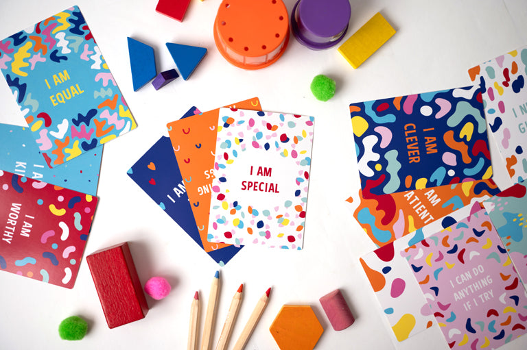 affirmation cards for children i am special in focus with other colourful cards all over the picture.