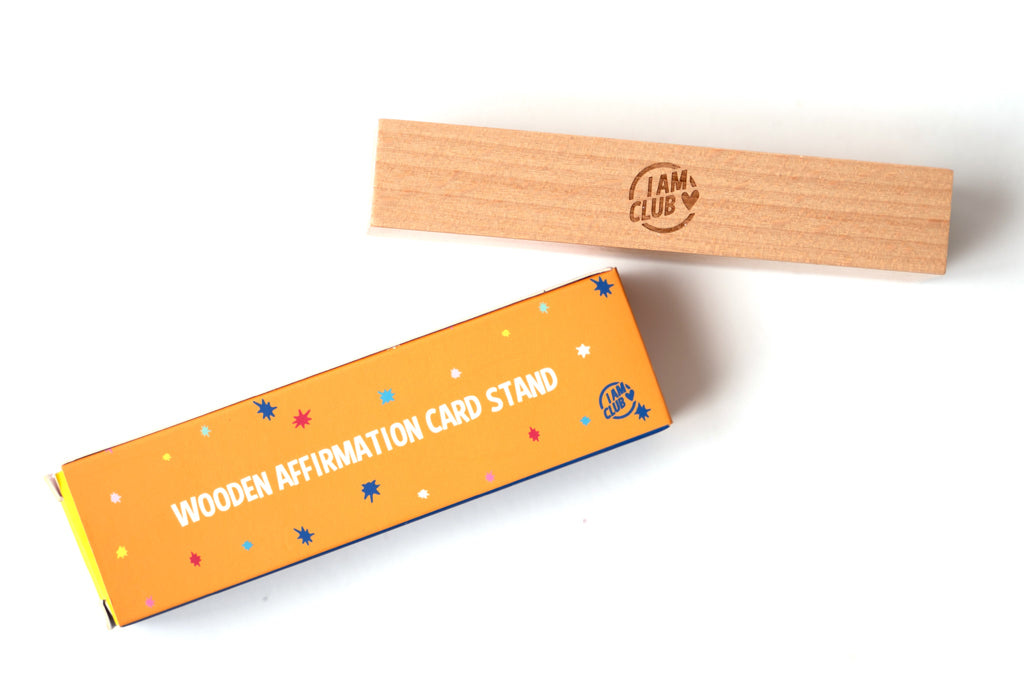 afiirmation card wooden stand on a white background with i am club logo