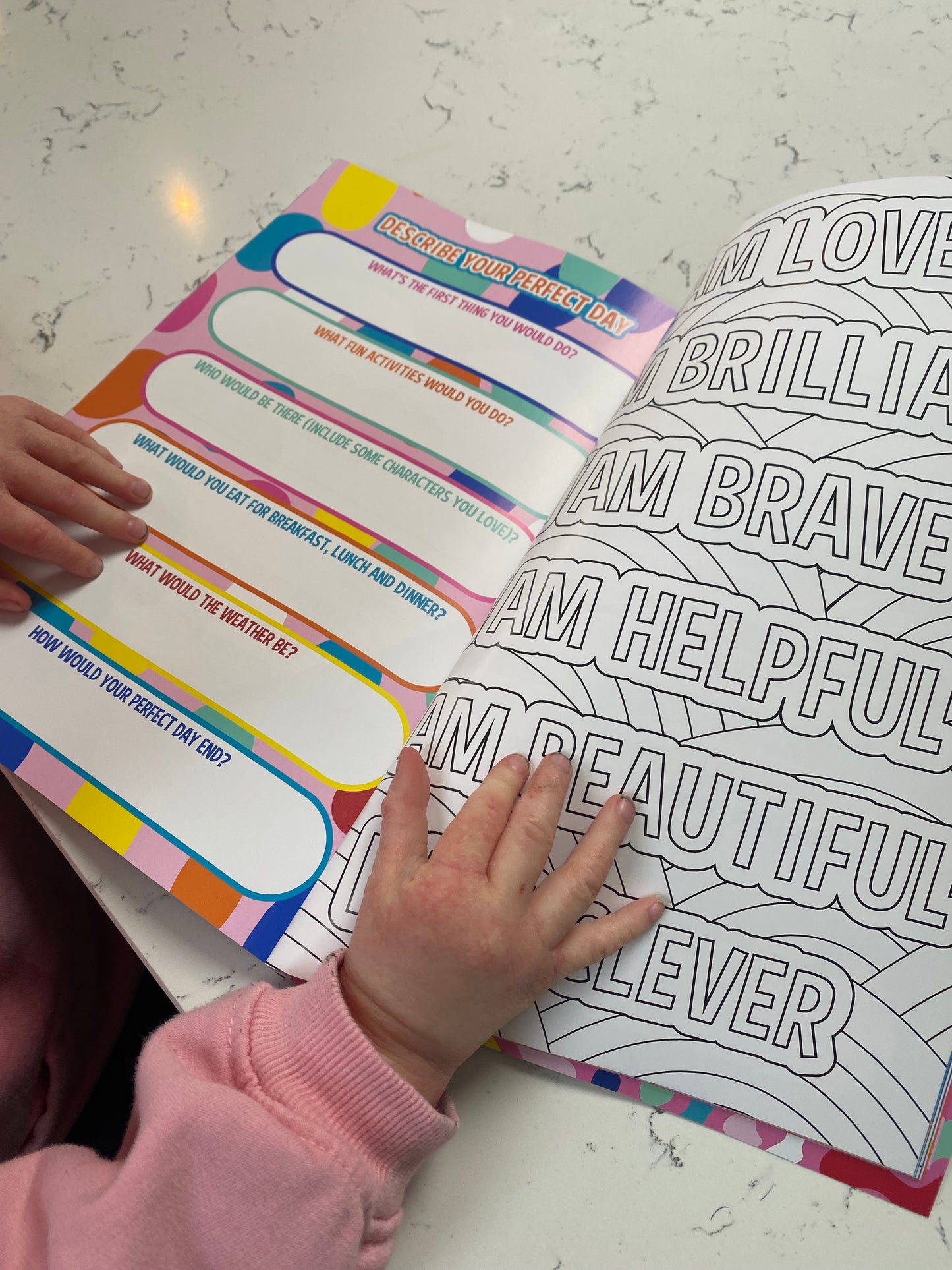 young girls hand holding the book down to read the this is me journal
