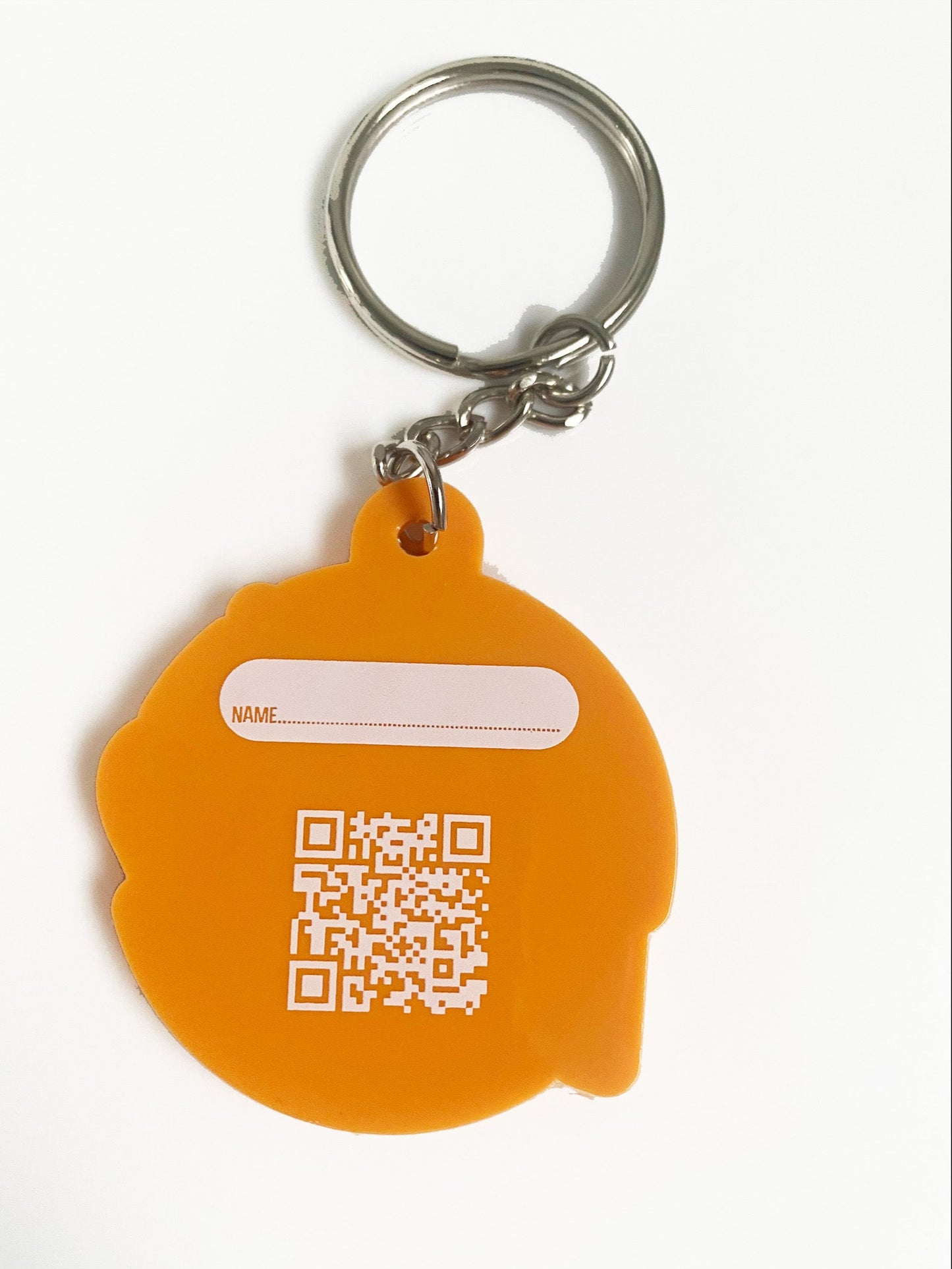 the back of the orange and yellow i am kind affirmation keyring showing the keyring
