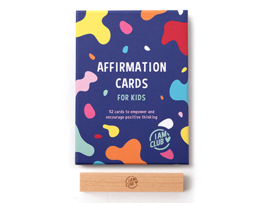 a pack of affirmation cards on a white backgrund with a wooden stand