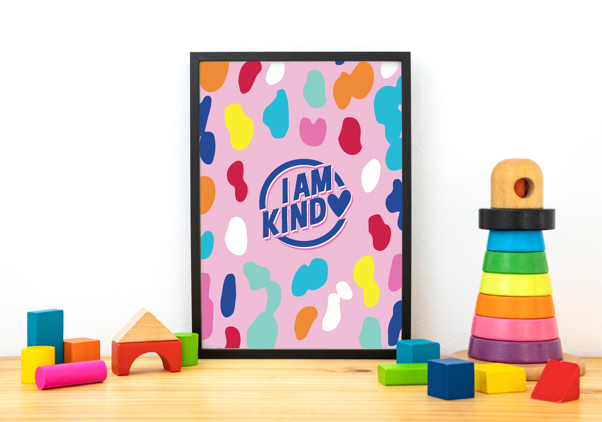 i am kind poster in pink with a bold pattern with black frame